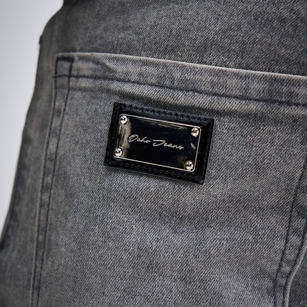 OCHO DUSK dark gray jeans, engraved rear-pocket metal plate on stitched black backing
